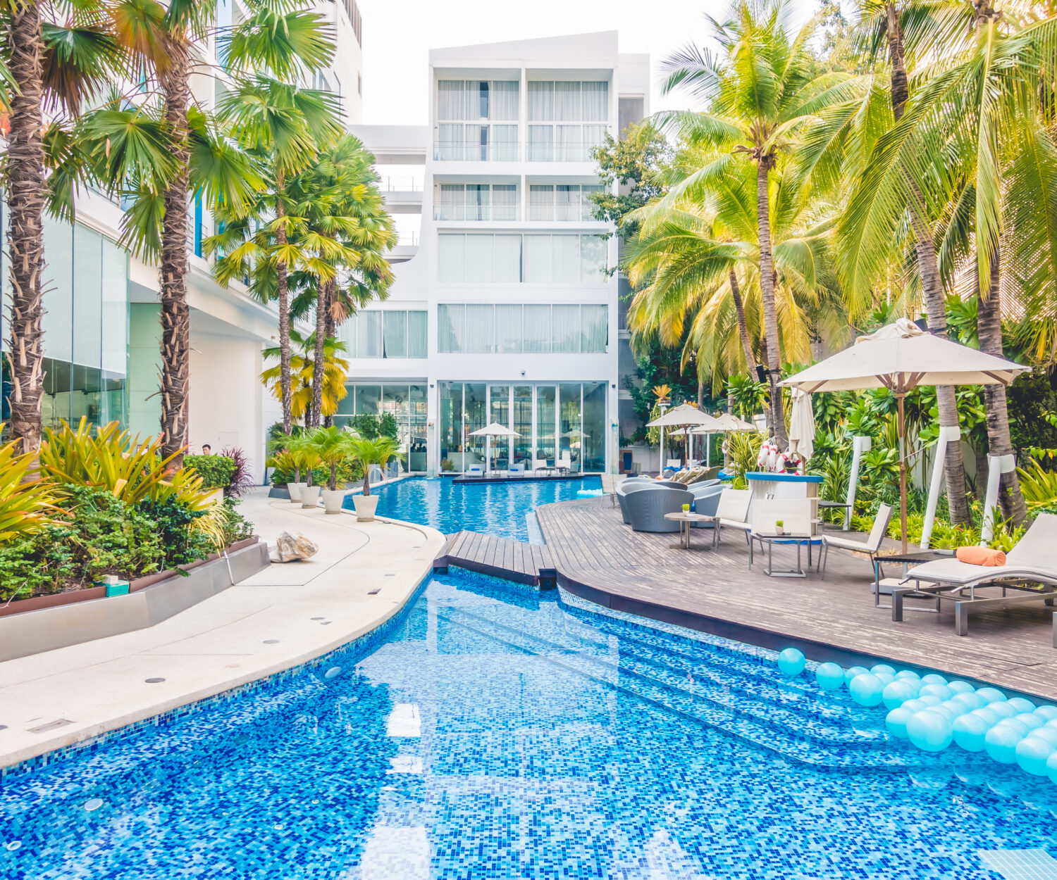 Umbrella pool and chair around beautiful luxury swimming pool in hotel resort - Vintage Light film Filter